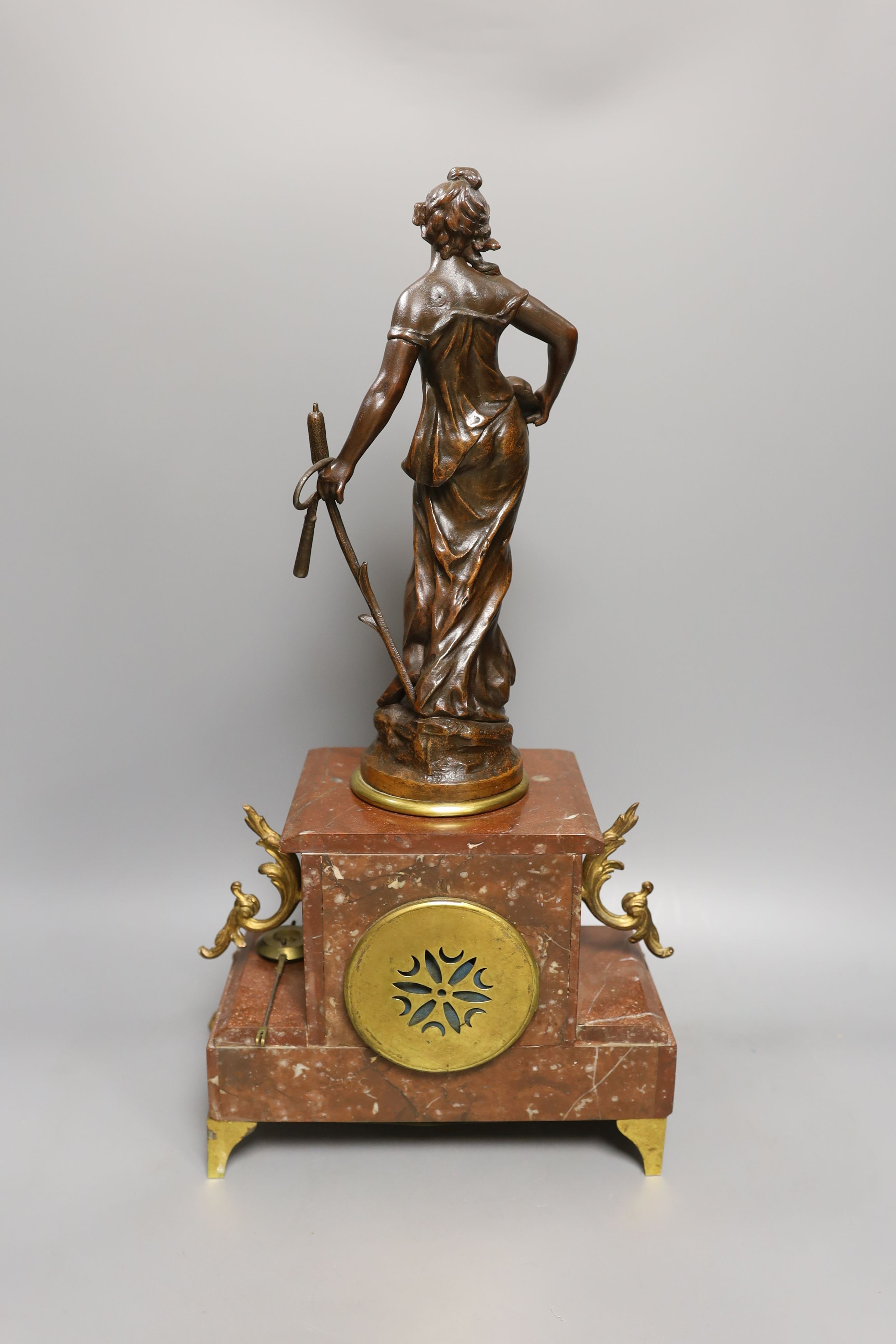 A French figurative early 20th century rouge marble clock garniture, Clock 51 cms high.